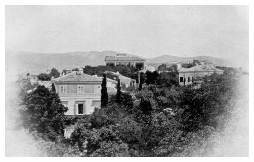 several large buildings among trees on a hillside