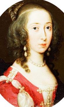 woman with pearl jewelry wearing fine red dress sewn with pearl accents