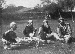 photograph of four seated men