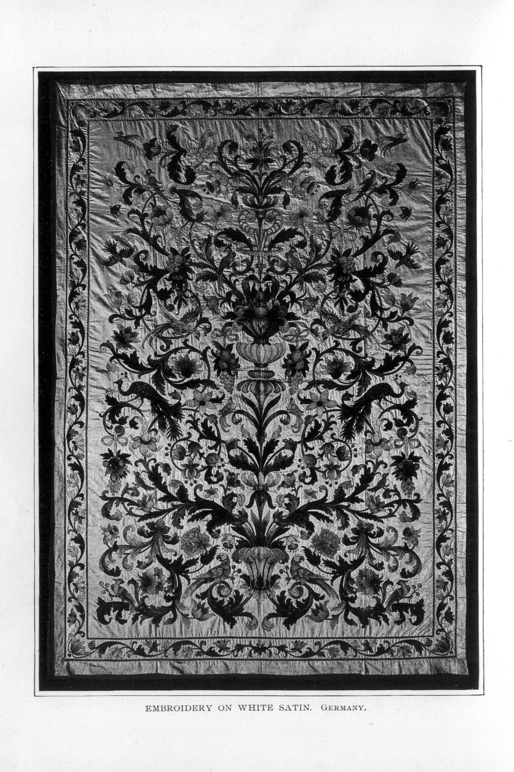 intricate embroidery decorated with flowers, scrolling branches, peacocks, and other birds