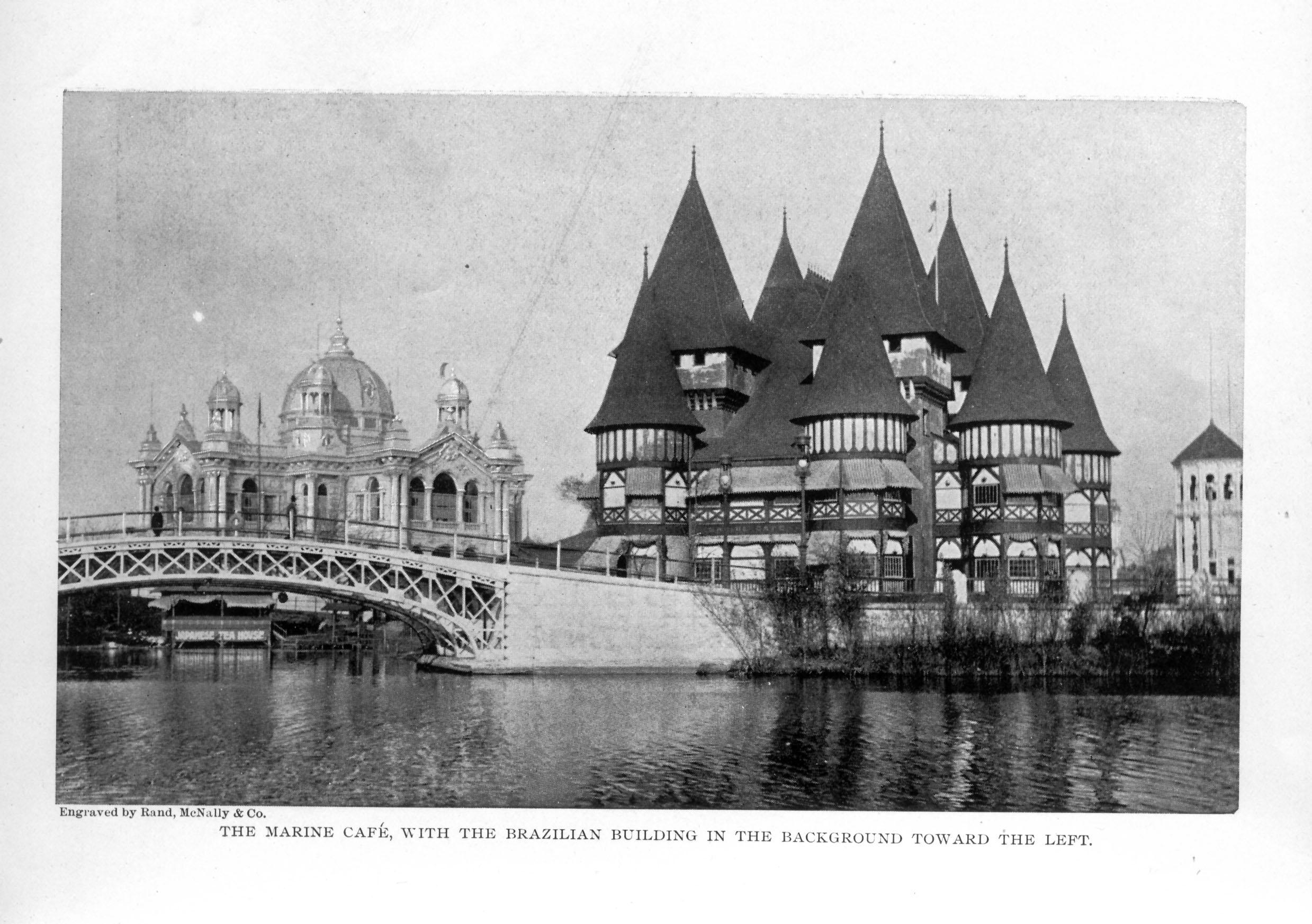 Tudor-esque building with many turrets on right and domed building on left, both by water's edge near a bridge