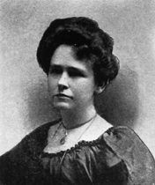 woman with dark hair and necklace