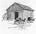 Barn with animals out front.