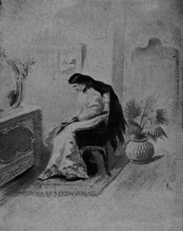 Woman with long flowing black hair sitting in a chair in front of a vanity.