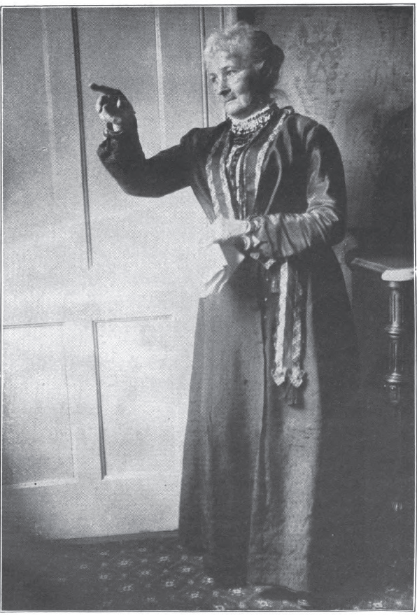 woman in Victorian dress pointing