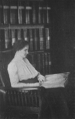 woman seated with large open book