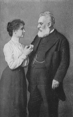 woman in long skirt holding hand of bearded man in suit